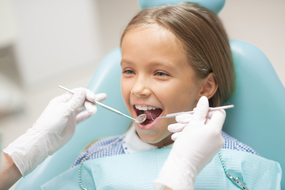 young girl going through a dental cleaning