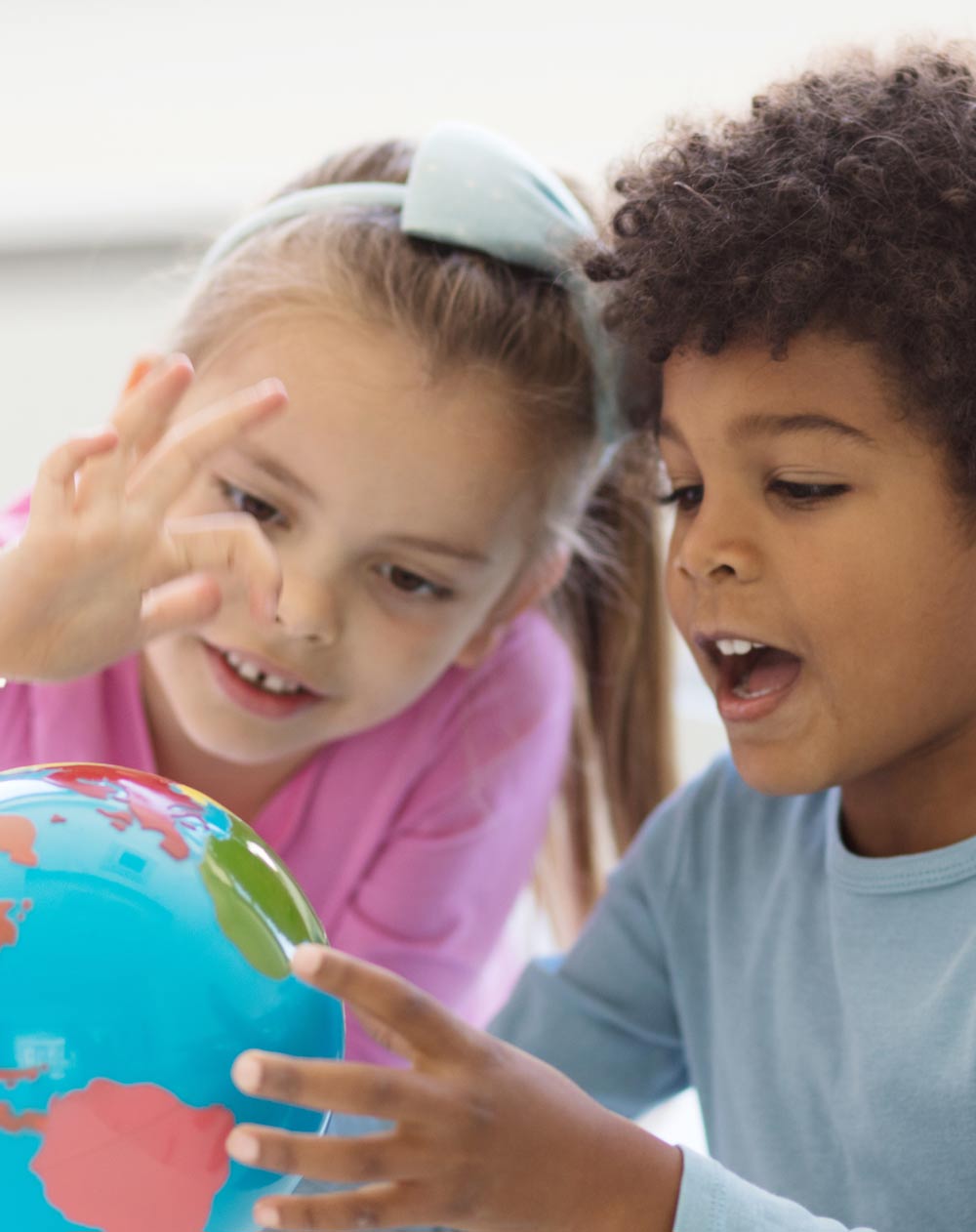 children playing with a globe