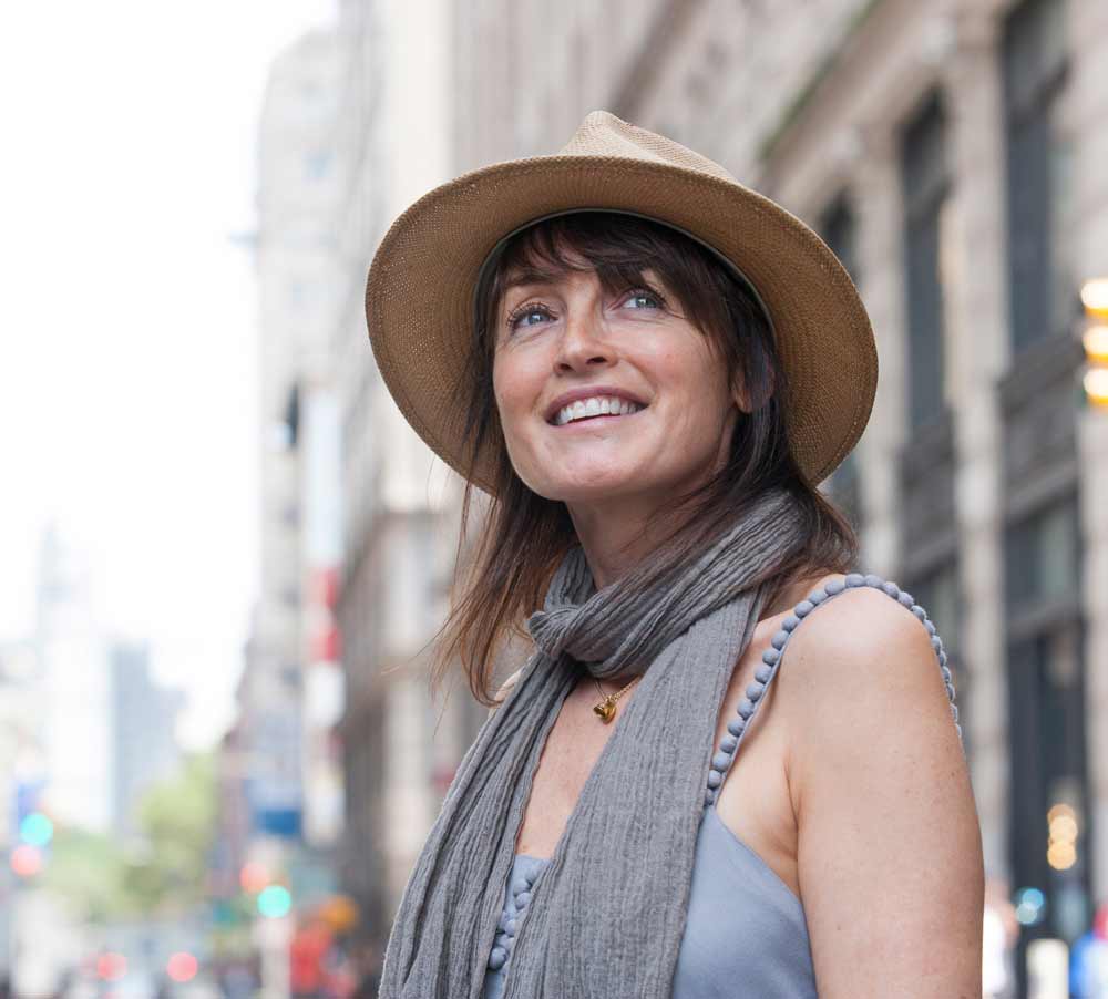 middle age women wearing a hat in the city